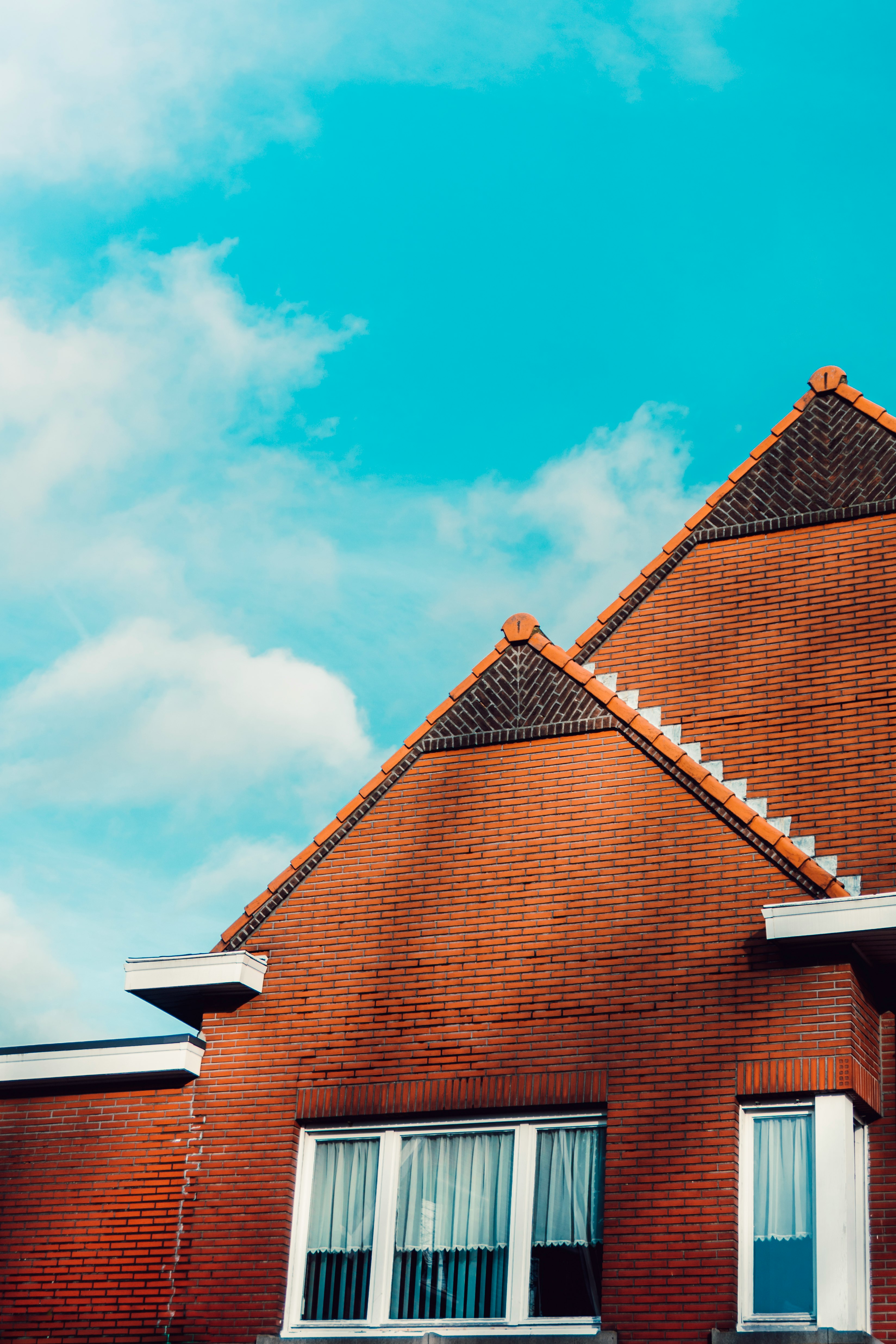 brown brick house under blue sky during daytime